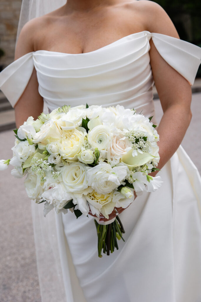 bride holding an all white textured wedding bouquet