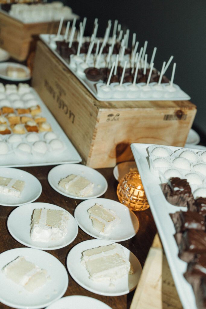 dessert table featuring slices of cake and mini dessert bites