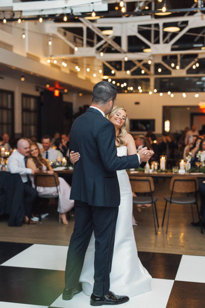 bride and groom's first dance on checkerboard dance floor
