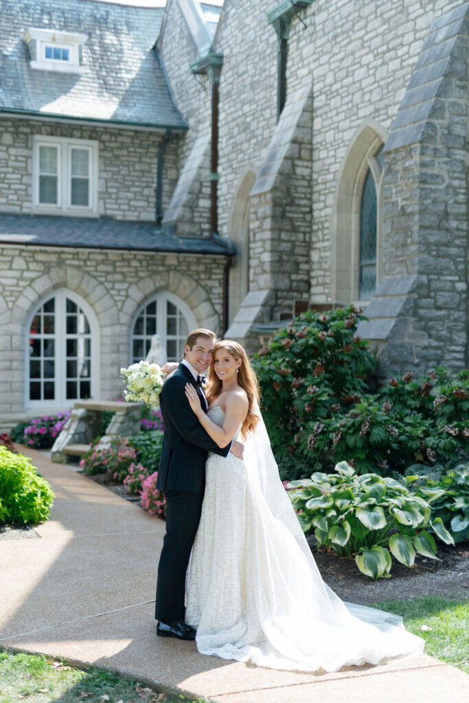 Bride and Groom pose outside of the church where they got married